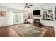 Bright living room featuring a fireplace, built-in shelving, and hardwood floors with a large area rug at 105 Blackberry Ct, Woodstock, GA 30188
