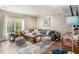 Comfortable living room with a sectional sofa, large window, and stylish accents at 105 Blackberry Ct, Woodstock, GA 30188