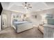 Inviting main bedroom with a tray ceiling, luxury carpet, and lots of natural light at 105 Blackberry Ct, Woodstock, GA 30188
