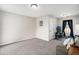 Open room with neutral carpet, fitness equipment, and a comfortable sofa at 105 Blackberry Ct, Woodstock, GA 30188