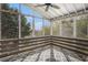 Relaxing screened porch with wooded views, ceiling fan, and decorative rug at 105 Blackberry Ct, Woodstock, GA 30188
