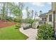 A spacious backyard features a stone patio, lush lawn, and mature trees at 1401 Kings Park Nw Dr, Kennesaw, GA 30152