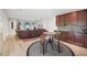 Finished basement with a brown sofa, wet bar, and light wood flooring at 1401 Kings Park Nw Dr, Kennesaw, GA 30152