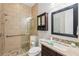 Modern bathroom featuring a walk-in shower with tile surround, stylish vanity, and updated fixtures at 1401 Kings Park Nw Dr, Kennesaw, GA 30152