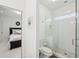 Bright bathroom with tiled walk-in shower featuring a glass door, a toilet, and access to the bedroom at 1401 Kings Park Nw Dr, Kennesaw, GA 30152