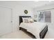 Cozy bedroom with a comfortable bed, decorative wreath, and a window offering a view of the outdoors at 1401 Kings Park Nw Dr, Kennesaw, GA 30152