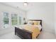 Bright bedroom with natural light, featuring a comfortable bed, a nightstand, and a ceiling fan at 1401 Kings Park Nw Dr, Kennesaw, GA 30152