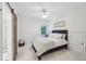 Bright bedroom with a sliding barn door entrance to the bathroom, comfortable bed, and a window with scenic views at 1401 Kings Park Nw Dr, Kennesaw, GA 30152