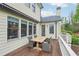 View of outdoor deck with dining table and chairs, adjacent to home's exterior at 1401 Kings Park Nw Dr, Kennesaw, GA 30152