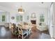 Bright dining room with floral chairs and accents, fireplace, and abundant windows at 1401 Kings Park Nw Dr, Kennesaw, GA 30152
