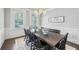 Dining room with large table and chairs, natural light, and modern chandelier at 1401 Kings Park Nw Dr, Kennesaw, GA 30152
