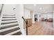 Bright hallway features hardwood floors, white trim, and staircase leading to the upper level of the home at 1401 Kings Park Nw Dr, Kennesaw, GA 30152