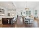 Open concept kitchen with large island, stainless appliances and seamlessly connected to a dining area with natural light at 1401 Kings Park Nw Dr, Kennesaw, GA 30152