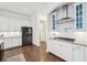 Modern kitchen featuring white cabinets, stainless steel appliances, and dark hardwood floors at 1401 Kings Park Nw Dr, Kennesaw, GA 30152