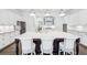 Bright kitchen featuring a large island with seating and pendant lighting, plus white cabinetry and stainless steel appliances at 1401 Kings Park Nw Dr, Kennesaw, GA 30152