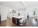 Spacious kitchen with an island and modern appliances, seamlessly connecting to a dining area and home office at 1401 Kings Park Nw Dr, Kennesaw, GA 30152