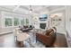 Bright living room with coffered ceilings, built-in shelves, fireplace, and large windows at 1401 Kings Park Nw Dr, Kennesaw, GA 30152