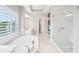 Luxurious bathroom featuring a soaking tub, glass shower, and ample natural light from plantation shutters at 1401 Kings Park Nw Dr, Kennesaw, GA 30152