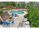 Inviting backyard featuring a sparkling pool, hot tub, and cozy fire pit area at 1401 Kings Park Nw Dr, Kennesaw, GA 30152