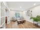 Sunlit sitting room featuring wood floors, neutral walls, and comfortable seating, ideal for relaxing or entertaining guests at 1401 Kings Park Nw Dr, Kennesaw, GA 30152