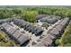 Aerial view of a townhome community featuring mature trees and a refreshing community pool at 4356 Jenkins Ne Dr, Roswell, GA 30075