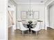Elegant dining room with modern chandelier, glass-top table, and stylish chairs, perfect for Gathering meals at 4356 Jenkins Ne Dr, Roswell, GA 30075