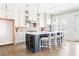 Spacious kitchen featuring a large center island, white cabinets, stainless steel appliances, and access to the outdoors at 4356 Jenkins Ne Dr, Roswell, GA 30075