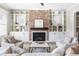 Cozy living room featuring a brick fireplace, built-in shelving, and comfortable seating, perfect for relaxation at 4356 Jenkins Ne Dr, Roswell, GA 30075