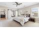 Relaxing main bedroom featuring a ceiling fan, shuttered windows, barn doors, and ensuite bath at 4356 Jenkins Ne Dr, Roswell, GA 30075