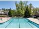 Inviting community pool featuring mature trees, pergola, lounge chairs, and ample seating at 4356 Jenkins Ne Dr, Roswell, GA 30075