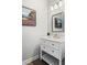 Stylish powder room featuring a white vanity with drawers, a decorative mirror, and modern lighting at 4356 Jenkins Ne Dr, Roswell, GA 30075