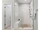 Contemporary walk-in shower featuring white subway tile, bench seating, and pebble floor at 4356 Jenkins Ne Dr, Roswell, GA 30075