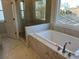Elegant bathroom showcasing a soaking tub, glass shower, and natural lighting at 631 Skytop Dr, Cumming, GA 30040