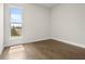 Bedroom with hardwood floors has natural light coming through a large window at 631 Skytop Dr, Cumming, GA 30040