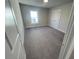 A spacious bedroom with plush carpeting and a bright window invites relaxation at 631 Skytop Dr, Cumming, GA 30040