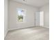 Bright bedroom with neutral carpeting and natural light coming in through one window at 631 Skytop Dr, Cumming, GA 30040