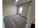 Welcoming bedroom featuring carpeting, neutral walls, and natural light from the window at 631 Skytop Dr, Cumming, GA 30040