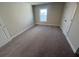A spacious bedroom with plush carpeting and a bright window invites relaxation at 631 Skytop Dr, Cumming, GA 30040