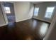 Bright bedroom showcasing windows, hardwood floors, and adjacent doorway at 631 Skytop Dr, Cumming, GA 30040
