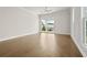This bedroom features light hardwood floors, recessed lighting, and a door to the outside at 631 Skytop Dr, Cumming, GA 30040
