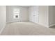 Bedroom with neutral carpet, white walls, a window and a closet with double doors at 631 Skytop Dr, Cumming, GA 30040