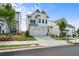 New construction home with white siding, a two-car garage, and manicured landscaping at 631 Skytop Dr, Cumming, GA 30040