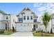 New construction home with white siding, a two-car garage, and manicured landscaping at 631 Skytop Dr, Cumming, GA 30040
