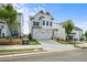 New construction home with white siding, a two-car garage, and manicured landscaping at 631 Skytop Dr, Cumming, GA 30040