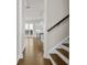 Hallway with hardwood floors leads to kitchen with pendant lights and white cabinets at 631 Skytop Dr, Cumming, GA 30040