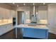 Modern kitchen with an island, white cabinets, quartz countertops, and stainless steel appliances at 631 Skytop Dr, Cumming, GA 30040