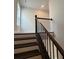 A modern staircase with wooden stairs and black metal railings at 631 Skytop Dr, Cumming, GA 30040