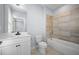 Bathroom featuring a bathtub with tiled surround and a vanity with modern fixtures at 1048 Claudette Colvin Ct, Atlanta, GA 30318
