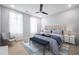 Bright bedroom featuring a plush bed, accent chair, and modern ceiling fan at 1048 Claudette Colvin Ct, Atlanta, GA 30318
