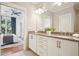 Modern bathroom vanity with double sinks, granite counters, & luxurious fixtures; bedroom view at 1199 Huff Nw Rd # 127, Atlanta, GA 30318